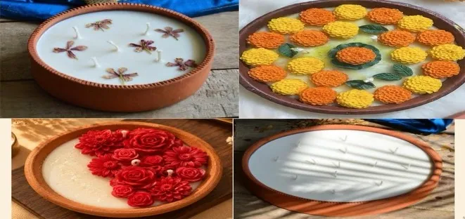 Wide terracotta urli candles decorated with marigold and rose wax flowers